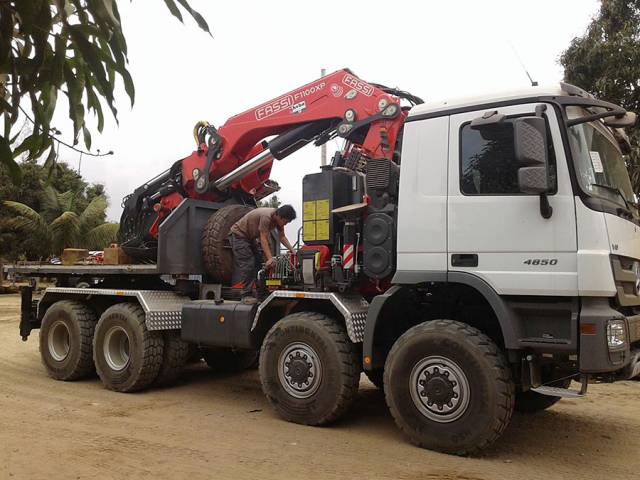 Mercedes-Benz Actros 4850 8x8 with Fassi 100t. crane at work in Angola Africa.
